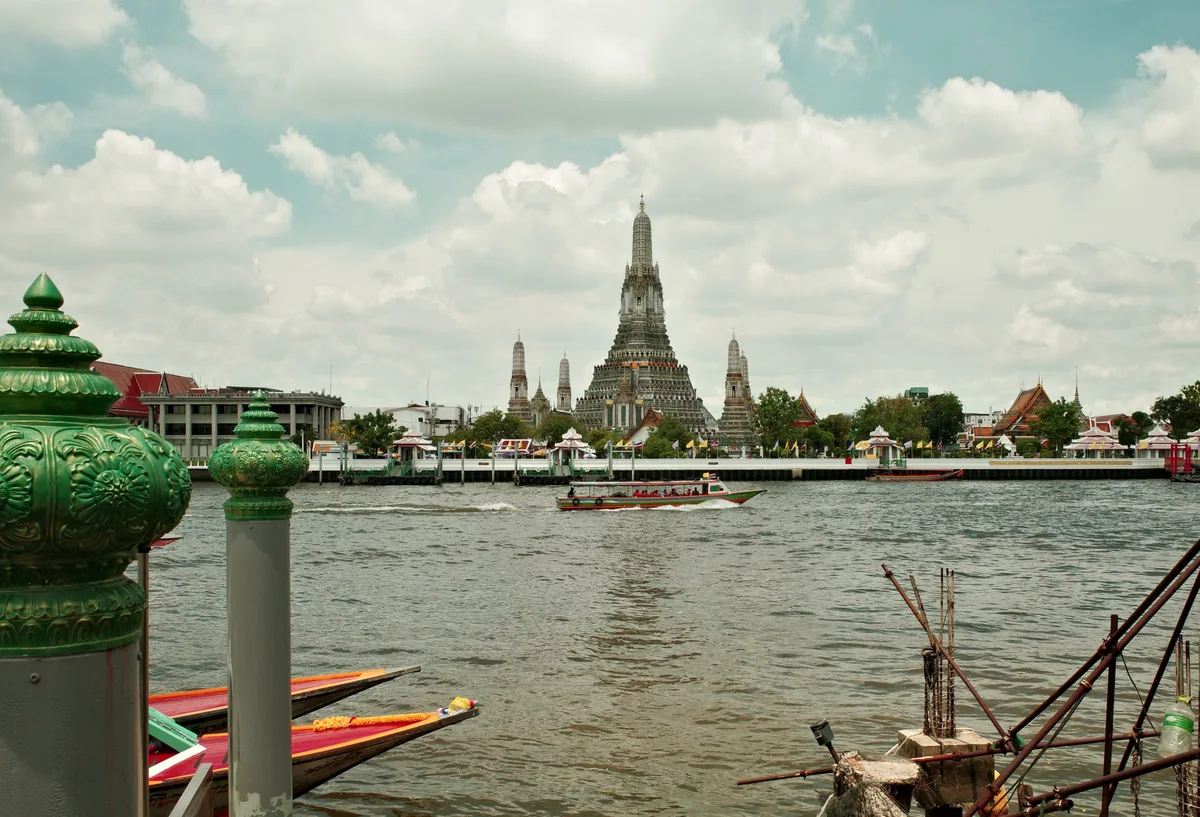 Thailand review view of a boat and a temple in the background
